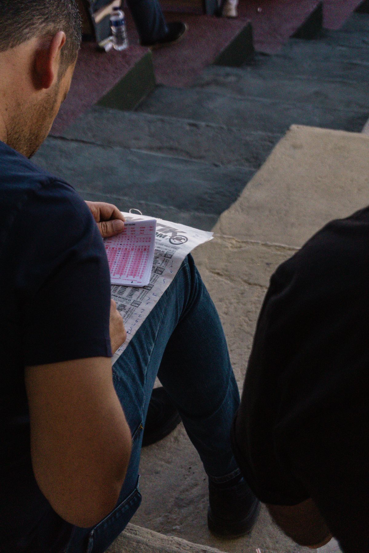 Man analyzing a racing form focusing on betting strategies